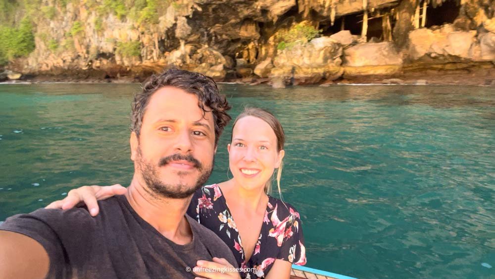 A couple and Viking Cave in Phi Phi islands Thailand