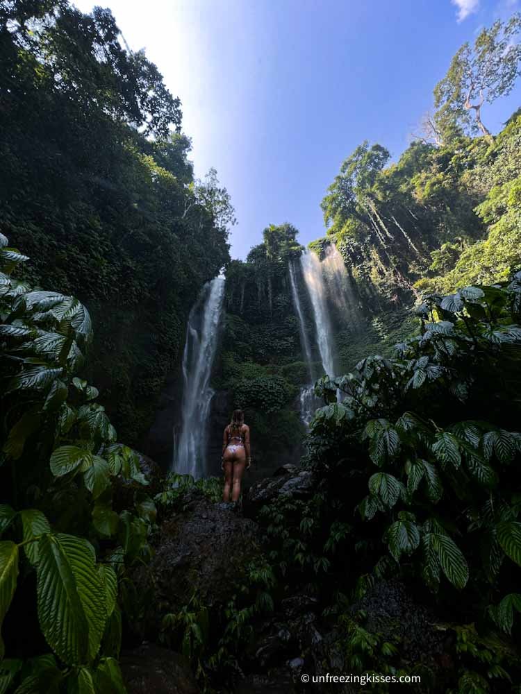 A woman and Sekumpul Waterfall Bali