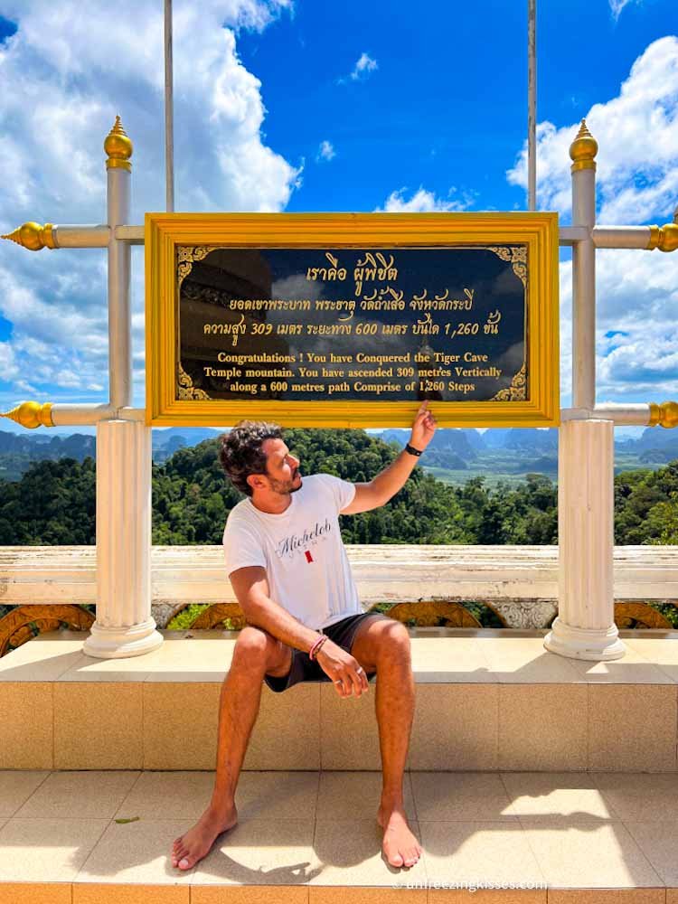 A man on the top of the Tiger Cave Temple Krabi Thailand