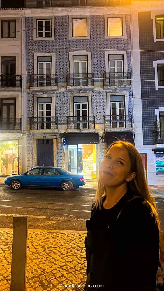 Woman in Bairro Alto Lisbon next to beautiful Portuguese style house